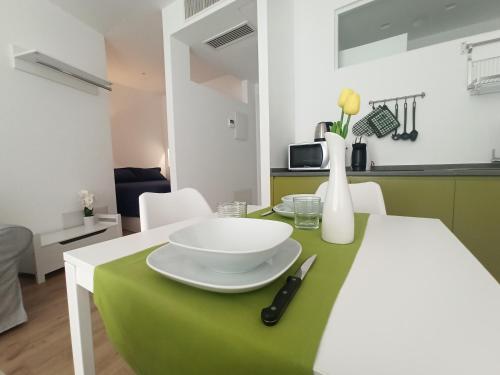 a green and white table with a white plate on it at Villa Ada Olbia in Olbia