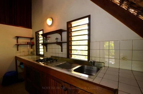 a kitchen with a sink and a window at L'antafa in Ambondrona