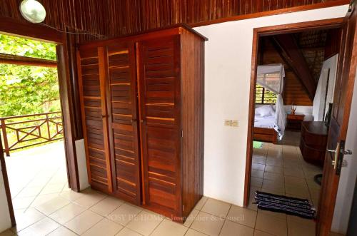 a wooden door in a room with a bedroom at L'antafa in Ambondrona