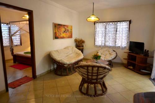a living room with two chairs and a table at L'antafa in Ambondrona