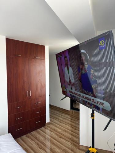 a living room with a large flat screen tv at Hotel SOGU TOWER in Ayacucho