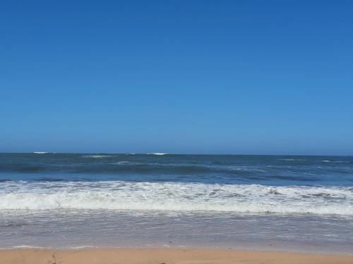 a person standing on a beach with the ocean at HEAVEN BEACH in Sidi Rahal