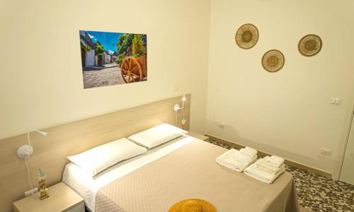 - une chambre avec un lit et une photo sur le mur dans l'établissement CityFlat Guest House, à Bari