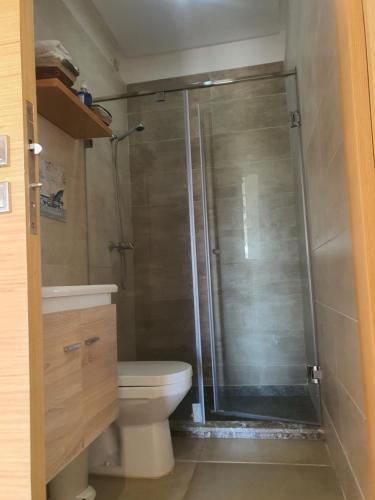 a bathroom with a shower and a toilet at HEAVEN BEACH in Sidi Rahal