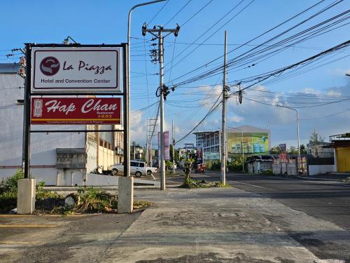 a sign for a pizza chain on the side of a street at Spacious 5-bedroom, 4-bath townhouse in Legazpi City in Legazpi