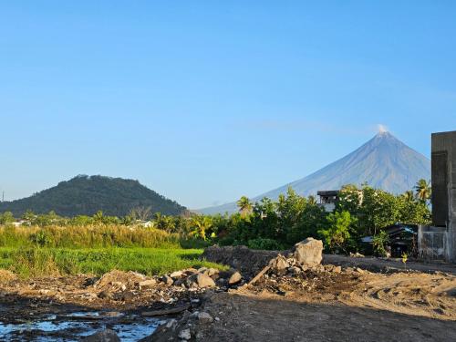 a mountain in the distance with a river in the foreground at Spacious 5-bedroom, 4-bath townhouse in Legazpi City in Legazpi