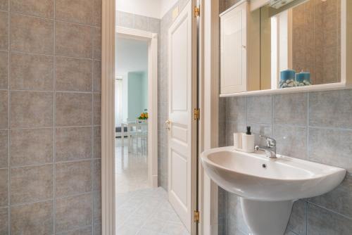a bathroom with a sink and a mirror at La Casa di Adalgisa in Fasano