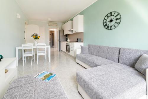 a living room with a gray couch and a table at La Casa di Adalgisa in Fasano