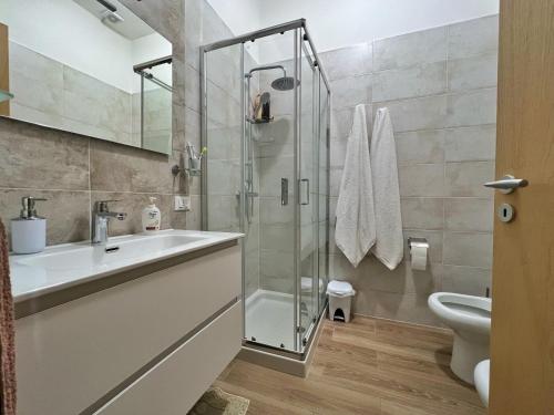 a bathroom with a sink and a shower at Casa Vacanza Rita in Marina di Pescoluse