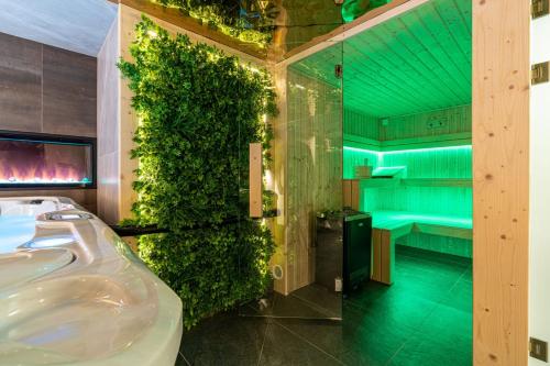 a bathroom with a sink and a green wall at Piaseckiego Residence SPA in Zakopane