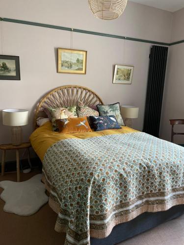 a bedroom with a bed with a comforter on it at Luxury flat in Totnes in Totnes