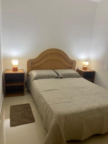 a bedroom with a large bed with two night stands at Casa Villa Serrano in Lençóis