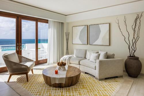 a living room with a couch and a coffee table at Aurora Anguilla Resort & Golf Club in Rendezvous Beach