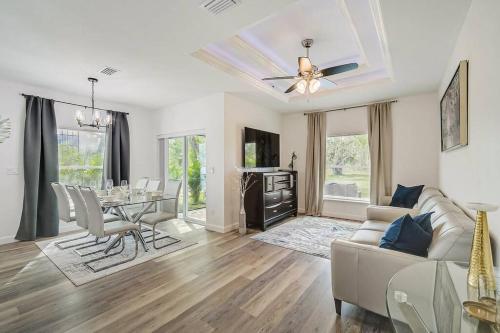 a living room with a couch and a table at SW Florida Luxury Modern Retreat, King Bed Suite , Close to Beaches / Golfing / Fishing / Air Ports , 2023 Built in Rotunda-West
