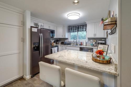 a kitchen with white cabinets and a granite counter top at Walk to Ski Resort! Sugar Mtn Haven with Lake Views in Sugar Mountain
