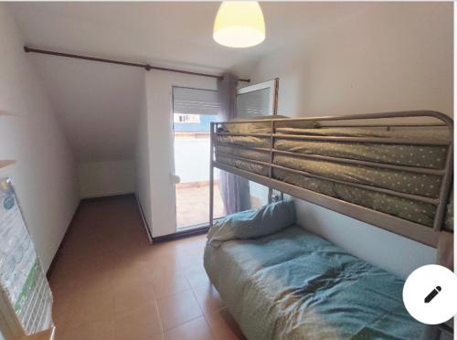 a bedroom with a bunk bed in a room at Piso en Ajo con piscina comunitaria in Ajo