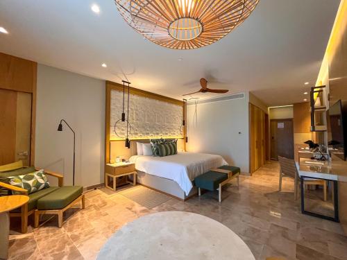 a bedroom with a bed and a living room at Haven Riviera Cancun - All Inclusive - Adults Only in Cancún