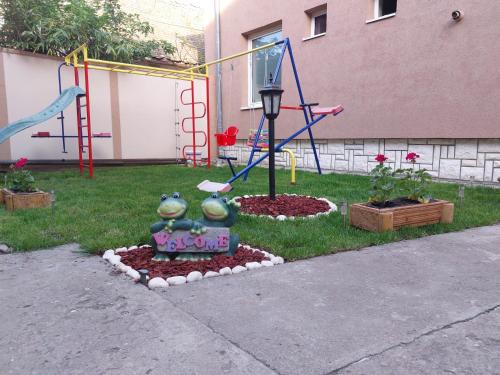a playground in a yard with at Royal TSV Rooms in Sombor