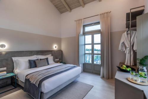 a bedroom with a large bed and a window at Octavia comfort bungalows with amazing view in Korinthos