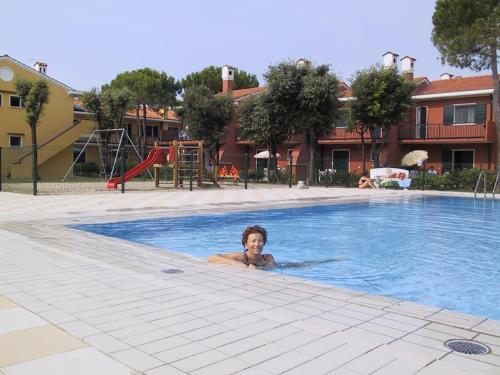 a young boy swimming in a swimming pool at Villaggio Michelangelo in Bibione