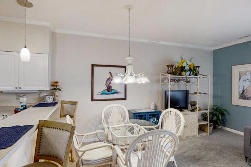 a kitchen and dining room with a table and chairs at Scotch Broom E-104 in Little River
