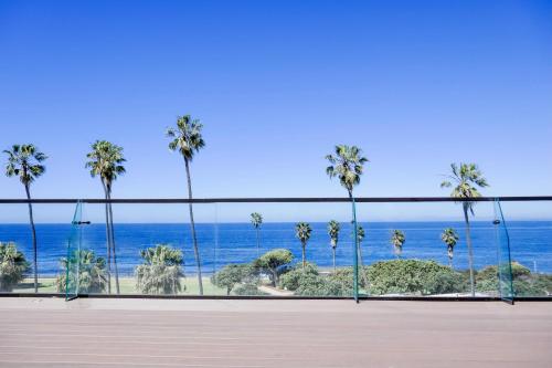 a room with a view of the ocean and palm trees at La Jolla Cove Suites in San Diego