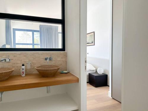 a bathroom with two sinks and a window at Grimaud villa in Grimaud