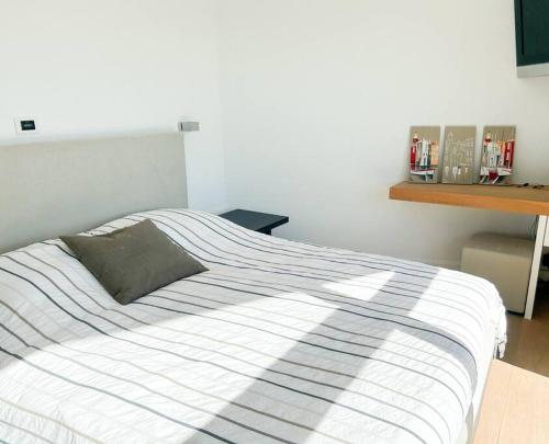a bedroom with a bed with a striped blanket at Grimaud villa in Grimaud