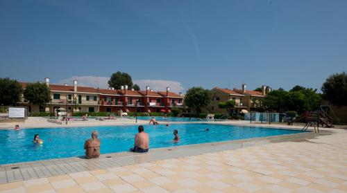 a group of people sitting in a swimming pool at Villaggio Michelangelo in Bibione