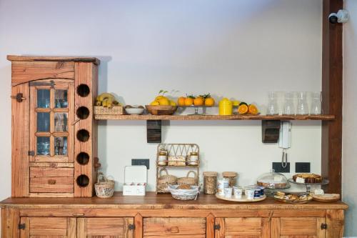 a wooden cabinet with food on top of it at B&B La Manica in Milazzo