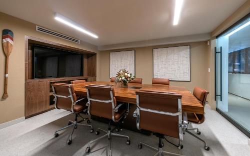 a conference room with a large wooden table and chairs at La Jolla Cove Suites in San Diego