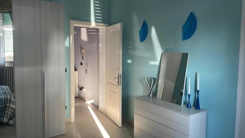 a room with a door and a television on a dresser at Azzurra House in Marina di Pisa