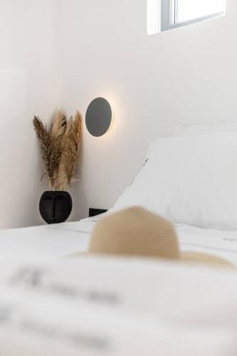a room with a table with a feather on the wall at FK Luxury Suites - Orkos Beach in Mikri Vigla
