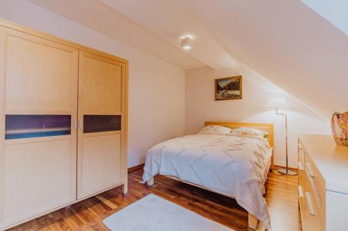 a bedroom with a bed and a dresser at Apartament Bukowa Mountain Wisla in Wisła