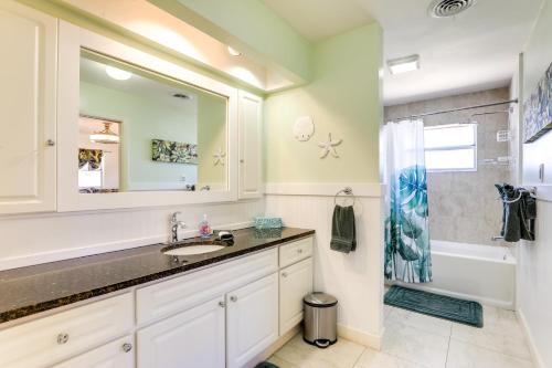 a bathroom with a sink and a tub and a mirror at Sarasota House with Private Pool - 4 Mi to Beach! in Sarasota