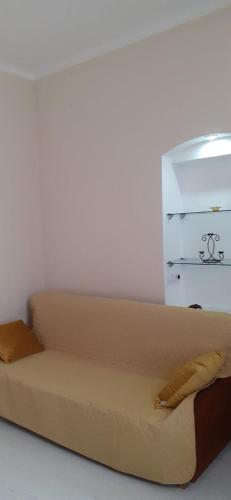 a couch with two pillows on it in a room at Центрові апартаменти in Ivano-Frankivsʼk