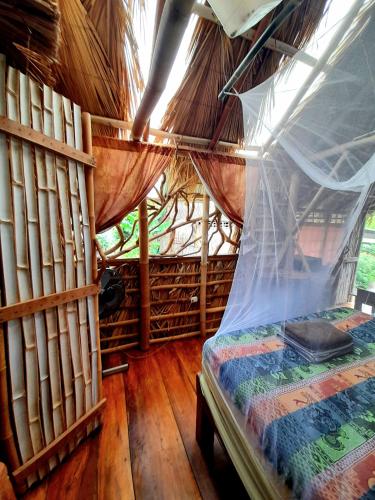 Ένα ή περισσότερα κρεβάτια σε δωμάτιο στο El Bamboo Cabins
