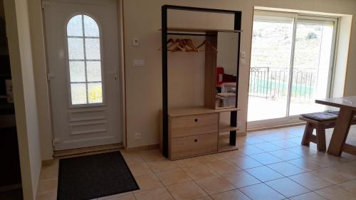 a room with a closet with a dresser and a window at Maison de Campagne aux deux Oliviers in Val Buëch-Méouge