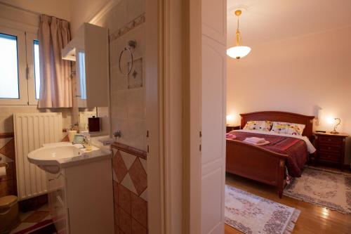 a bathroom with a bed and a sink in a room at My Nafpaktos Resort in Nafpaktos