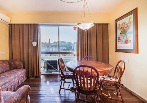 a living room with a table and chairs and a couch at Ritter Hotéis in Porto Alegre