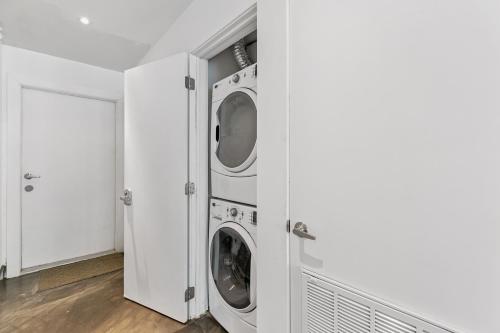 a white laundry room with two washer and dryer at Upscale Modern Villa Private w Terrace in Bahia Mar Beachfront Resort, Heated Pool! in South Padre Island