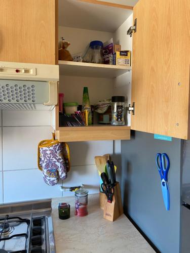 a kitchen with an open pantry with utensils at Rincones del Placer, un lugar repleto cariño in Valparaíso