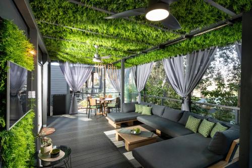 a patio with a couch and ivy on it at Mobile Home JOY Porton Biondi in Rovinj