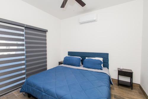 a bedroom with a blue bed with blue pillows at Residence 4 in Puerto Peñasco