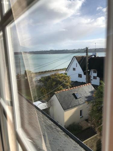 a view of the ocean from a window at Esmée - Havre de Charme sous les Toits in Perros-Guirec