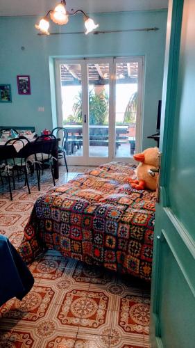 a bedroom with a bed with a stuffed animal on it at The Secret Garden Maratea - Casa di Sery in Maratea