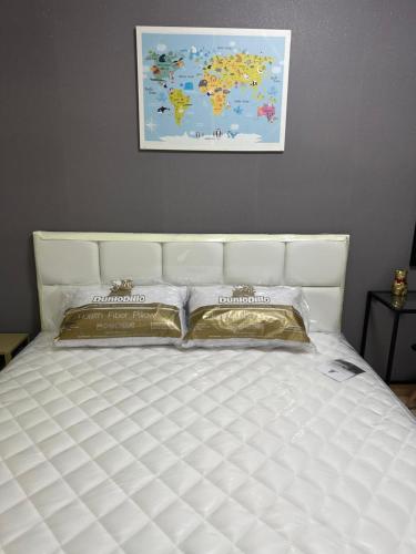 a white bed with two pillows on top of it at S Villa @Impact Muangthongthani in Pak Kret