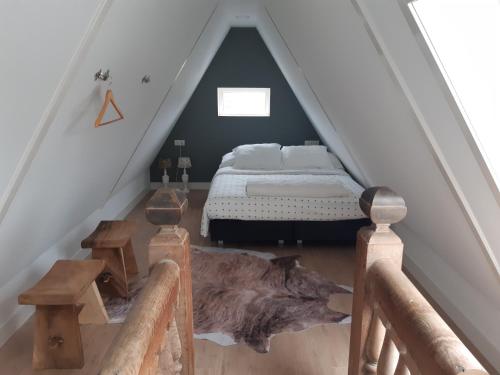 a bedroom with a bed in a attic at BenB Humblebee in Alkmaar