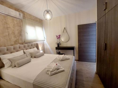 a bedroom with a bed with towels on it at Amare suite in Perivólia