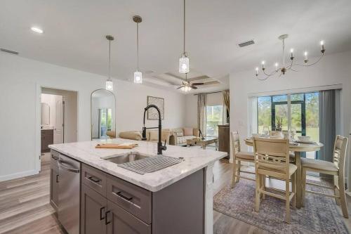 a kitchen and living room with a table and chairs at South West Florida Family Home, 3 Bedroom,2 Bathroom, King bed suite, Close to Beaches, Parks, Fishing, Golfing, Kayaking in Rotonda West